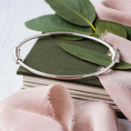 Megan Fringe Bangle image silver bangle on book handmade contemporary design fidget jewellery